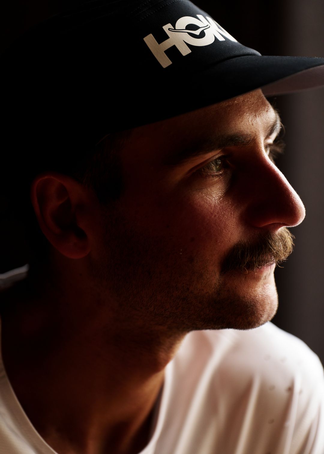 Close up of man in Hoka hat